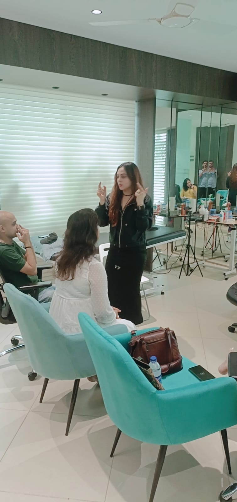 Vibha Jain explaining a hypnotherapy technique to participants during a session