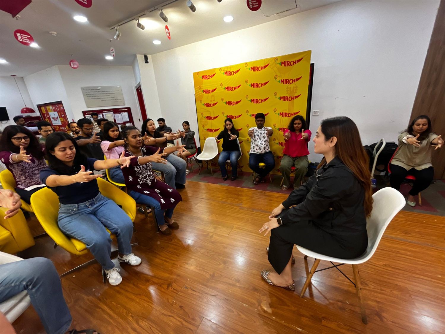 Vibha Jain leading a group hypnotherapy demonstration with participants seated in a circle